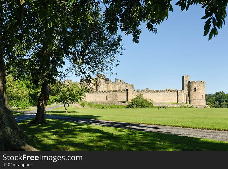 Alnwick Castle framed by leaves