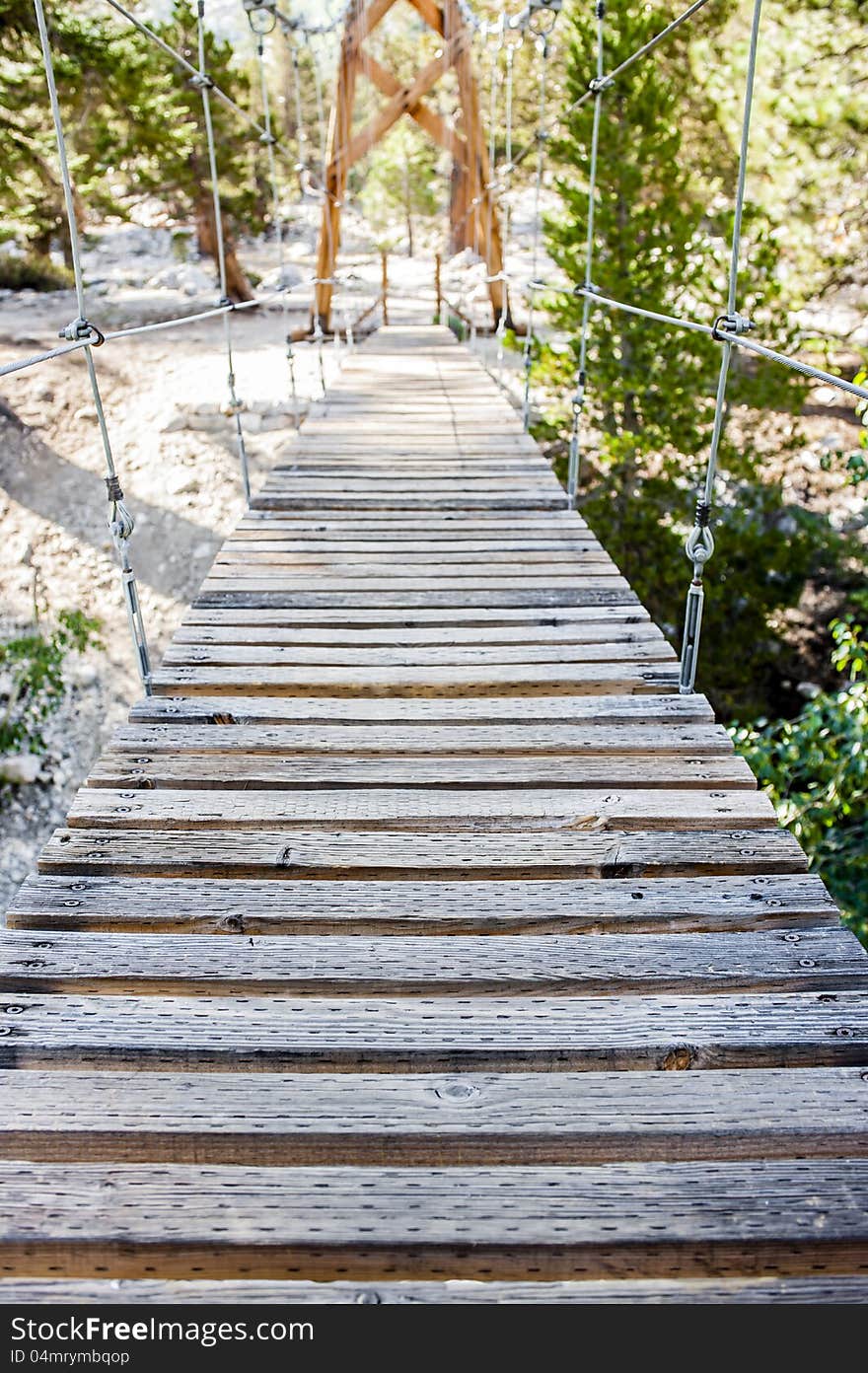 First person view of a swinging footbridge in Kings Canyon National Park. First person view of a swinging footbridge in Kings Canyon National Park.