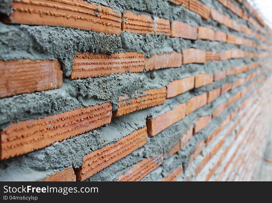 Close up of brick wall ending in infinity construction