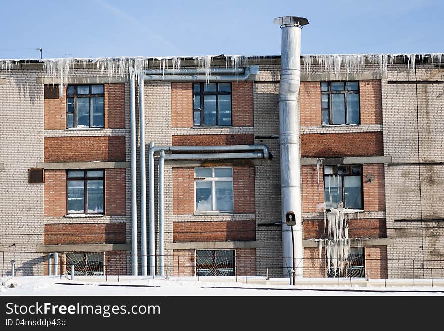 Industrial building with many icicles by cold winter day. Industrial building with many icicles by cold winter day