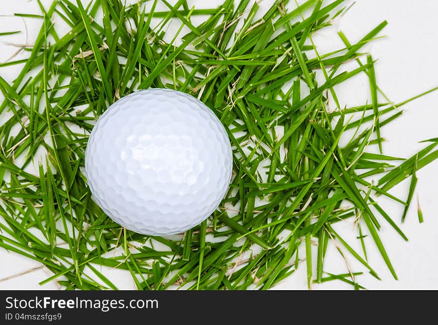 White golf ball top view on grass