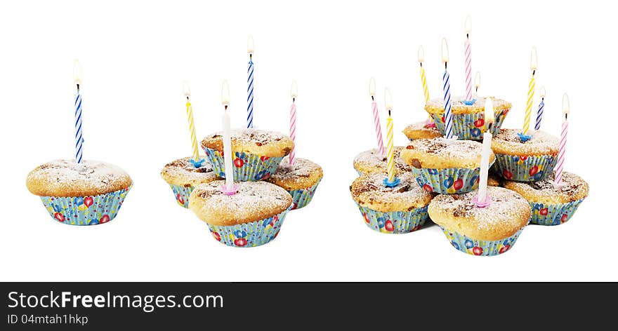 Holiday muffins with lit candles on white isolated background