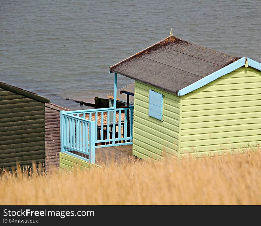 Photo of single wooden beach hut overlooking whitstable sea front. Photo of single wooden beach hut overlooking whitstable sea front.