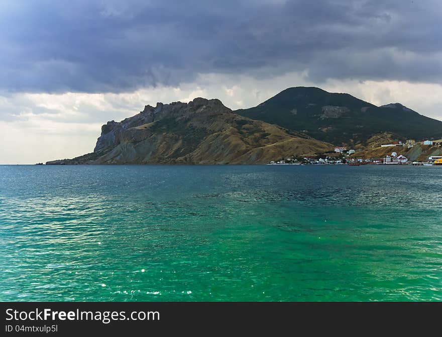 View from the sea to the mountains when the storm coverage. View from the sea to the mountains when the storm coverage