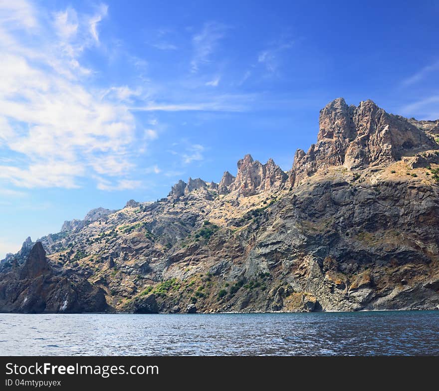 Rocks at sea against the blue sky