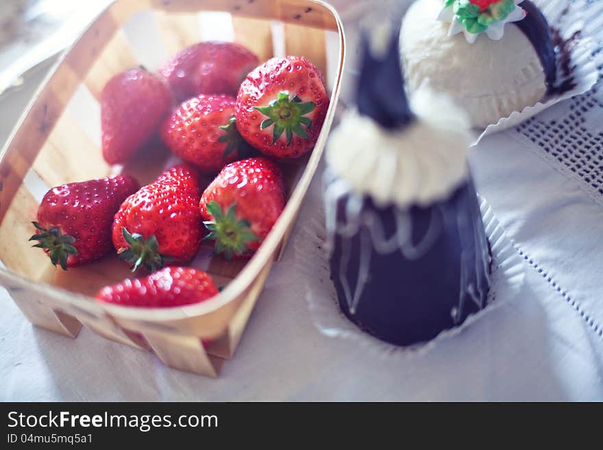 Basket of strawberries next to pastries