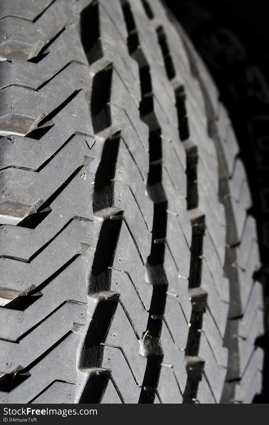 Worn black tire tread of truck. Worn black tire tread of truck