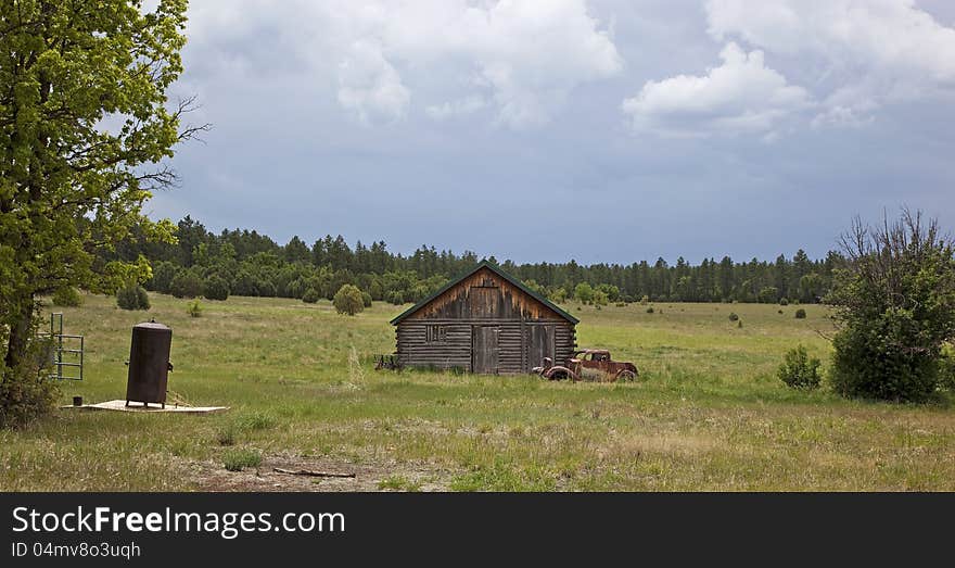 Country Barn and antique truck with approaching storm