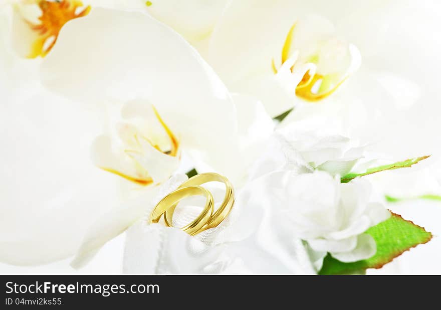 Close up on wedding bouquet (white orchid) and rings. Close up on wedding bouquet (white orchid) and rings