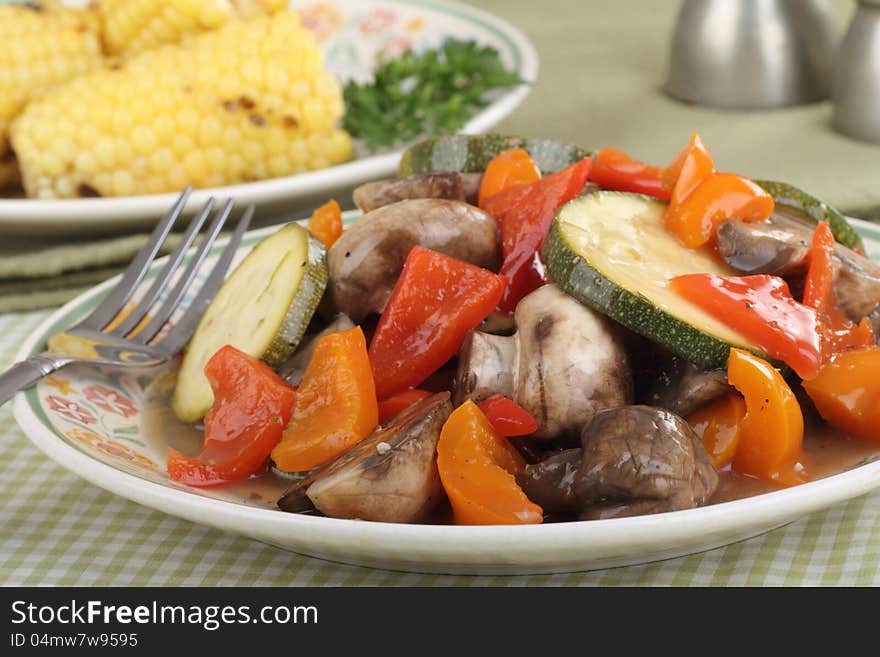 Fried vegetables with zucchini, peppers and mushrooms on a plate