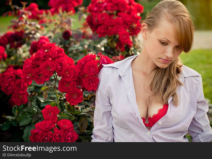 Beautiful young woman in flower garden