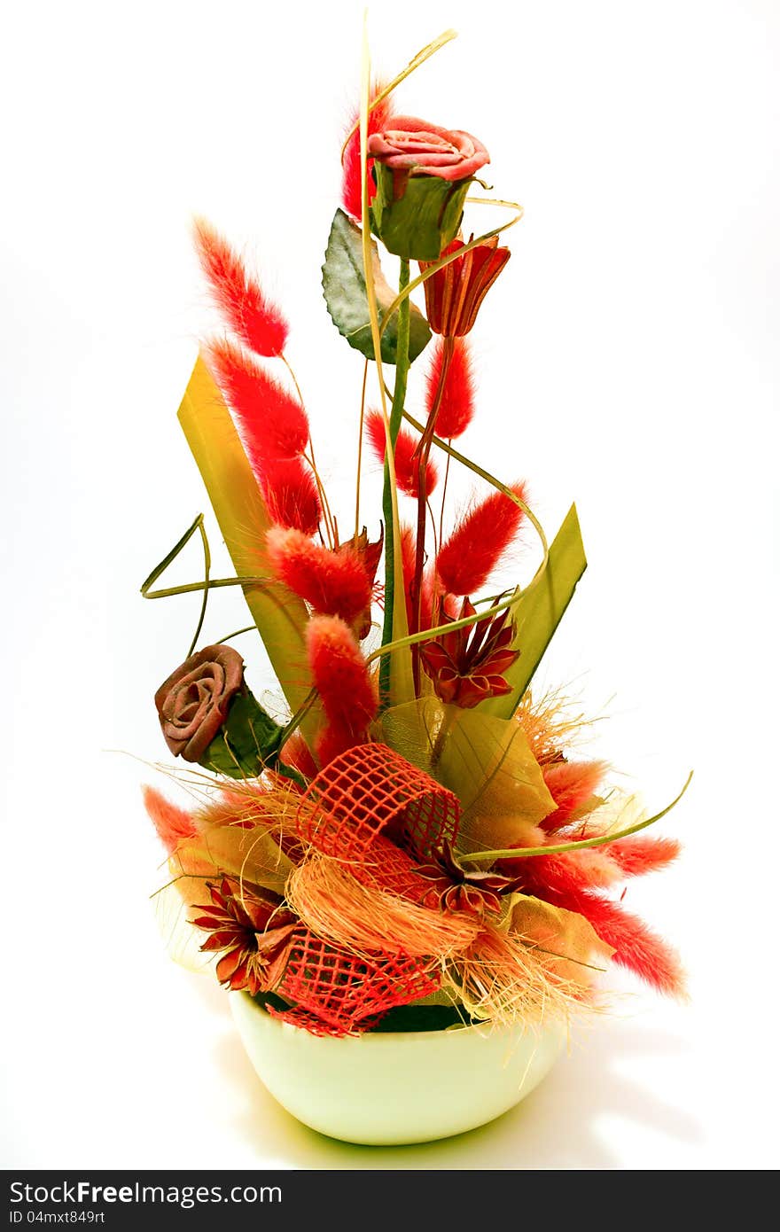 Artificial flowerarrangement with roses on a white background. Artificial flowerarrangement with roses on a white background