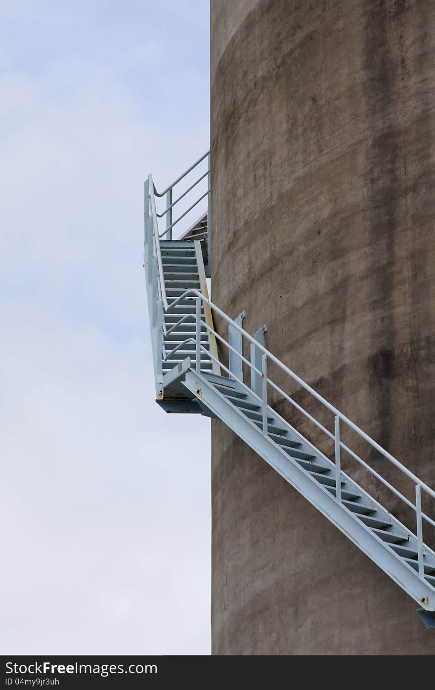 Wrap-around stairs leading up the side of a concrete silo. Wrap-around stairs leading up the side of a concrete silo.