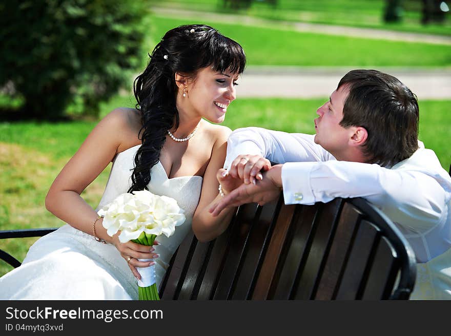 Bride and groom on wooden bench