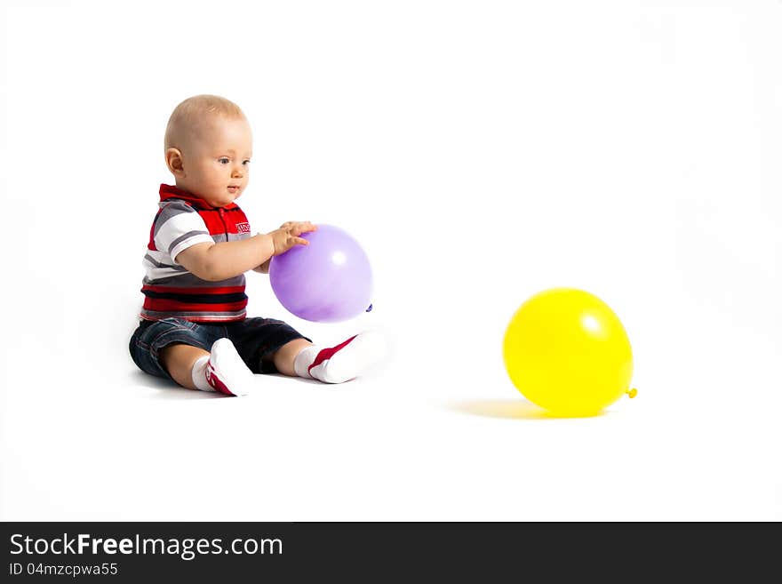 Child sit with balloons sit on the floor. Child sit with balloons sit on the floor