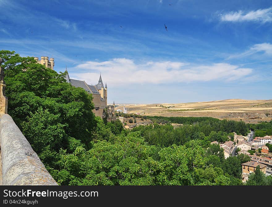 The fairytale alcazar castle of Segovia. View of the surrounding countryside. Castile region, Spain. The fairytale alcazar castle of Segovia. View of the surrounding countryside. Castile region, Spain