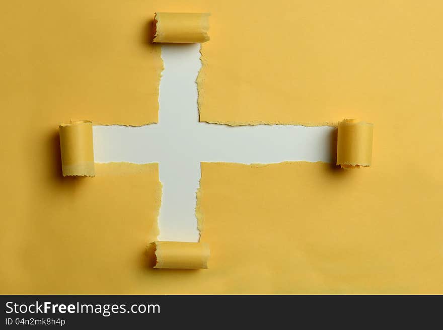 Rip paper in the shape of the cross with white in the background