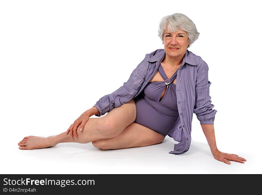 Attractive Senior Citizen Lady wearing a swimming suit on a white background