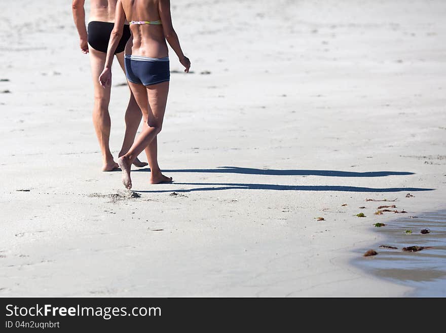 Couple walks along the beach