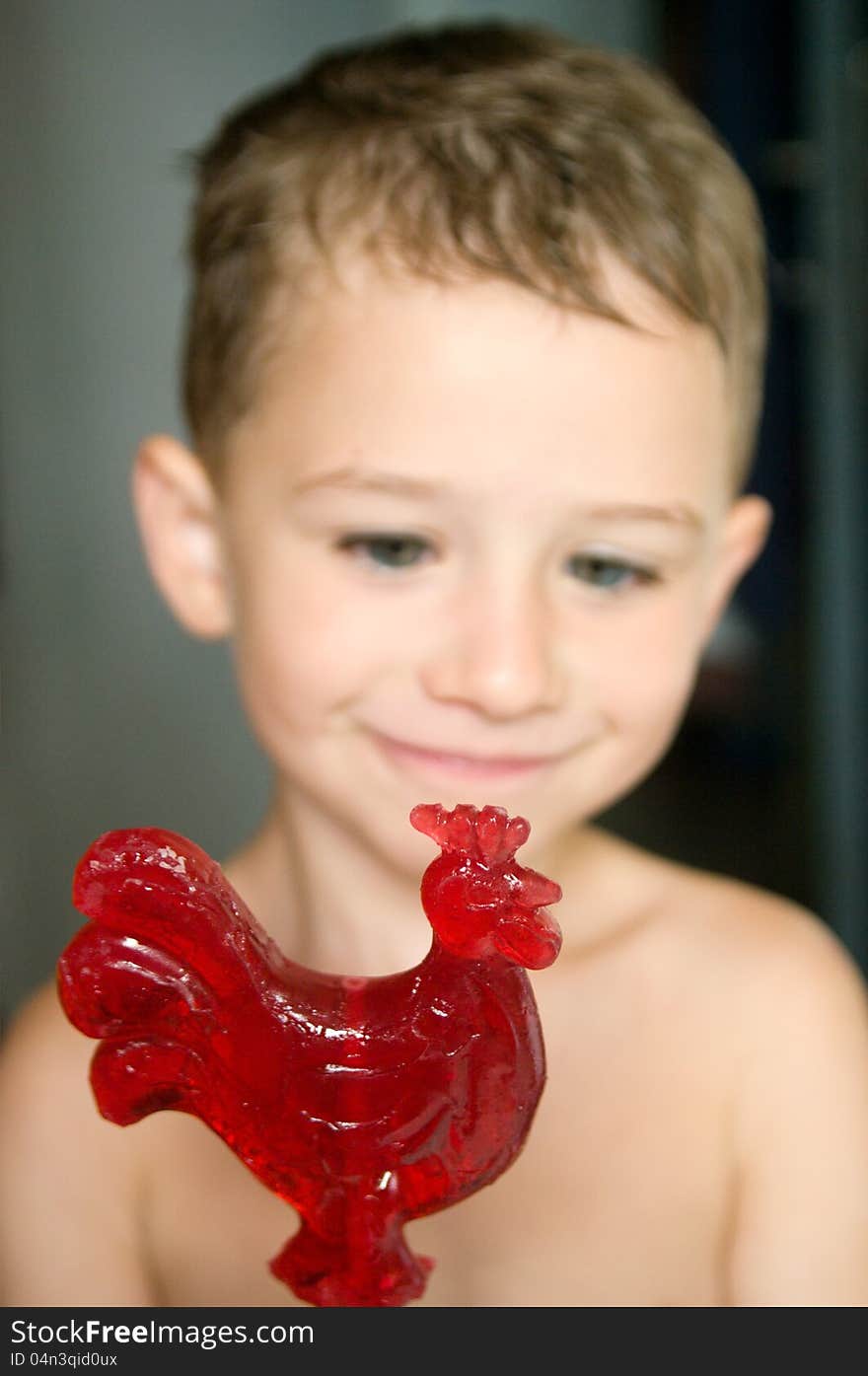 Red candy in hands of a kid