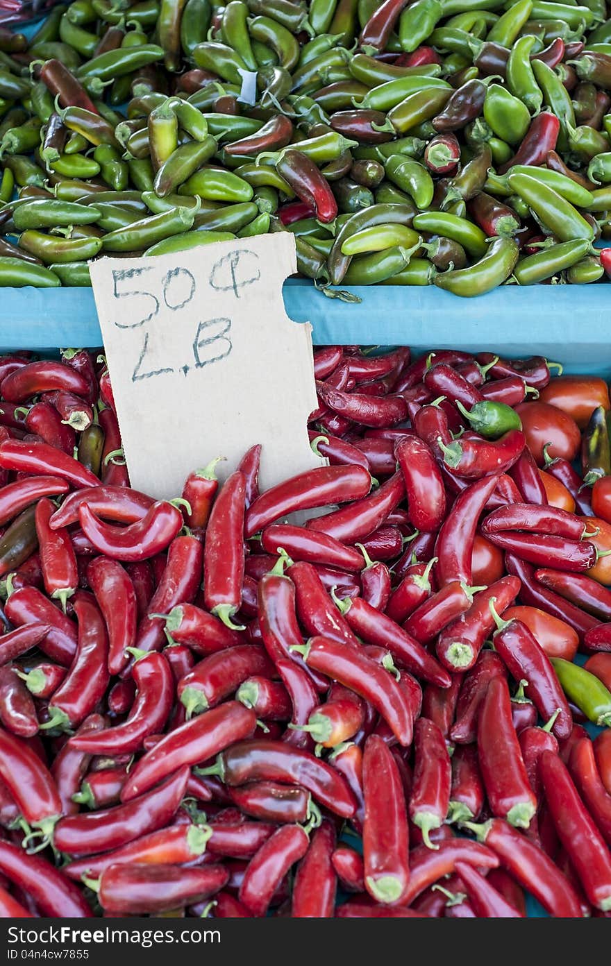 Fresh, green and red hot peppers for sale at local farmers market. Fresh, green and red hot peppers for sale at local farmers market.