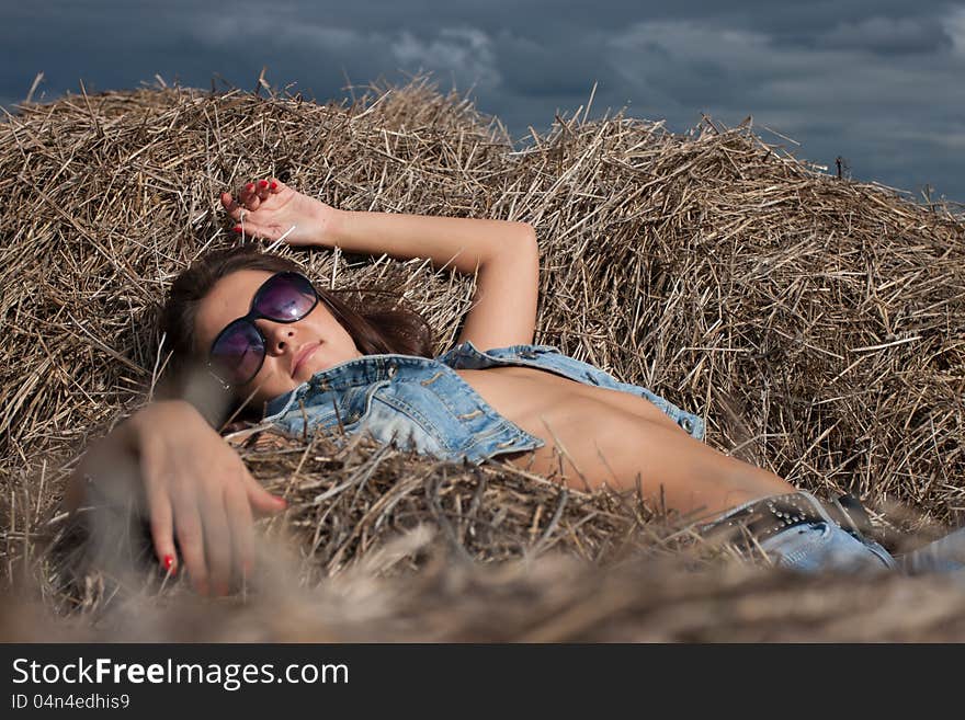 Girl on the pile of hay