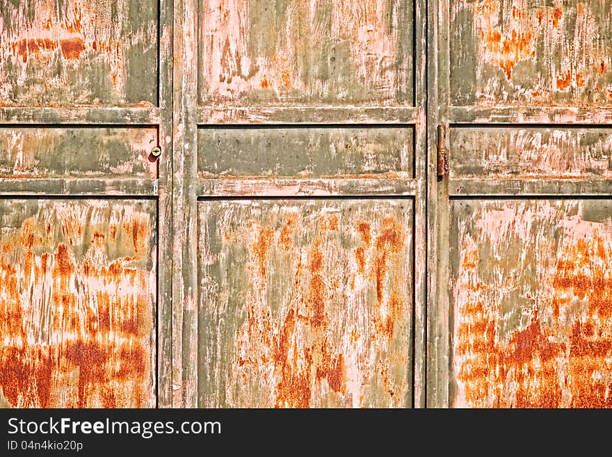 Old rusty door with hinge and keyhole