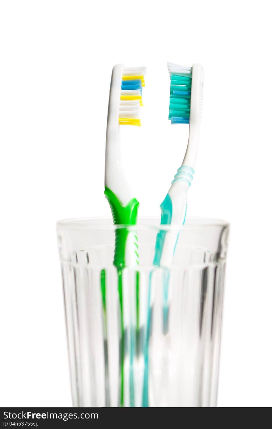 Closeup Toothbrushes in transparent glass. Isolated of background