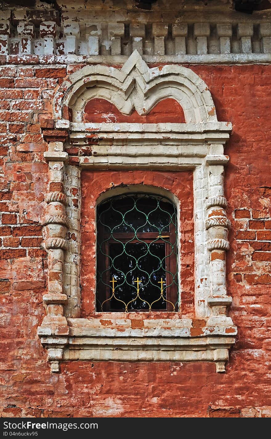 Peeling brick wall of an ancient monastery and stucco window. Peeling brick wall of an ancient monastery and stucco window