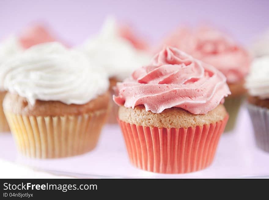 Homemade pink and white cupcakes on the plate