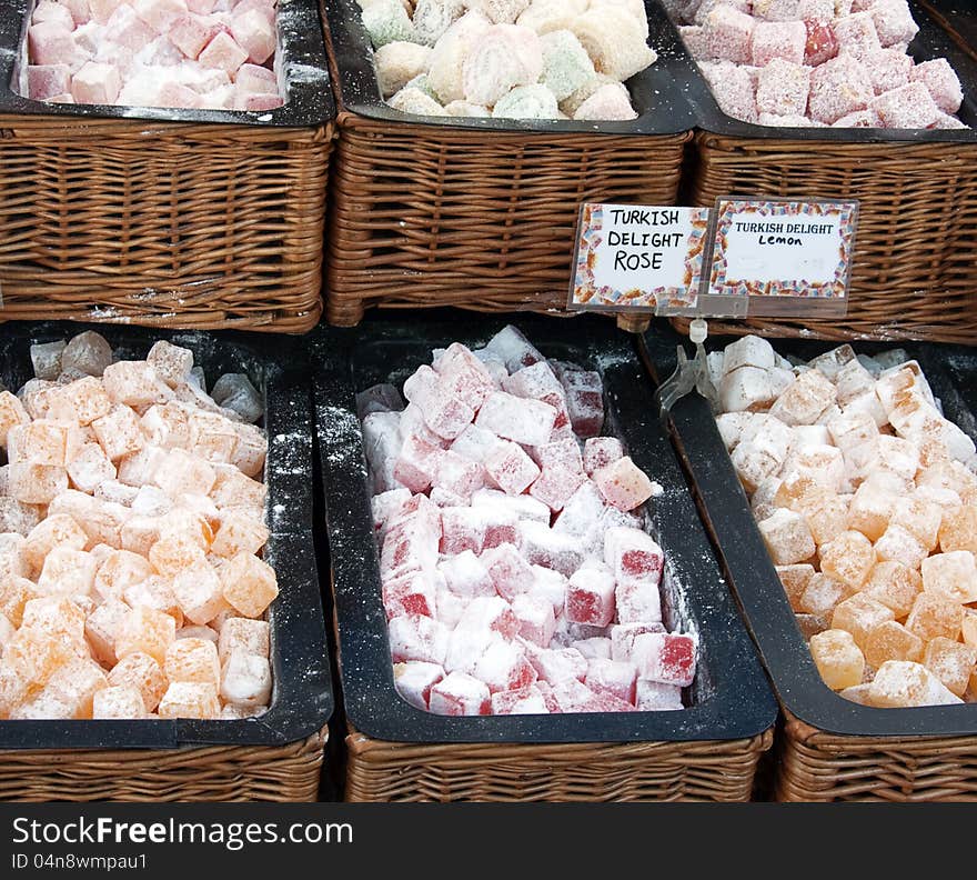 Assorted turkish delight sweet for sale displayed in woven baskets at the market stall.