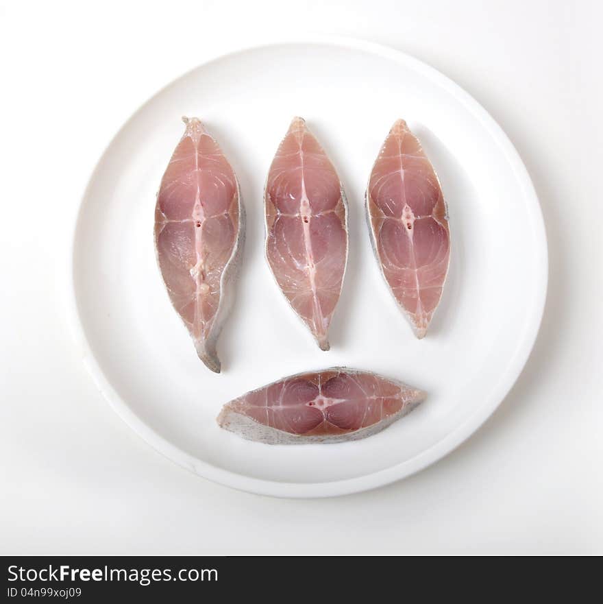 Sliced fish on white plate