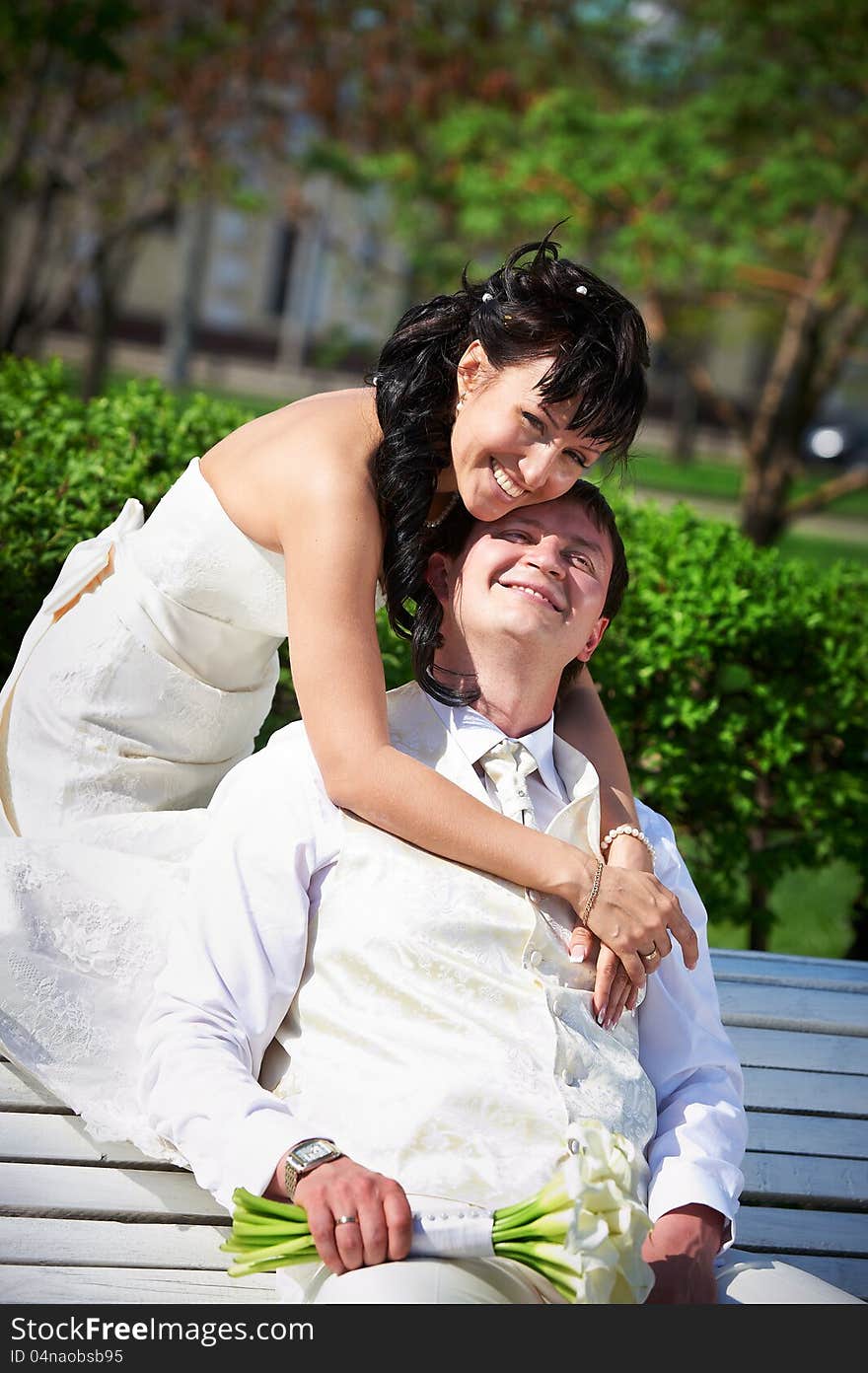 Bride and groom on bench