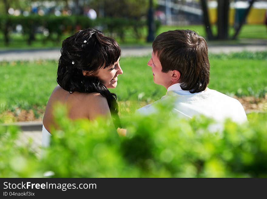 Happy bride and groom on bench