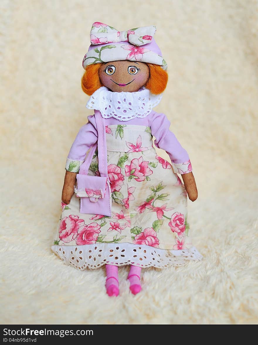 Handwork - a doll in a pink dress and a hat with a bag. Handwork - a doll in a pink dress and a hat with a bag