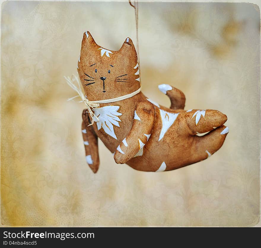 Flying brown cat with white drawing and a bow. Flying brown cat with white drawing and a bow