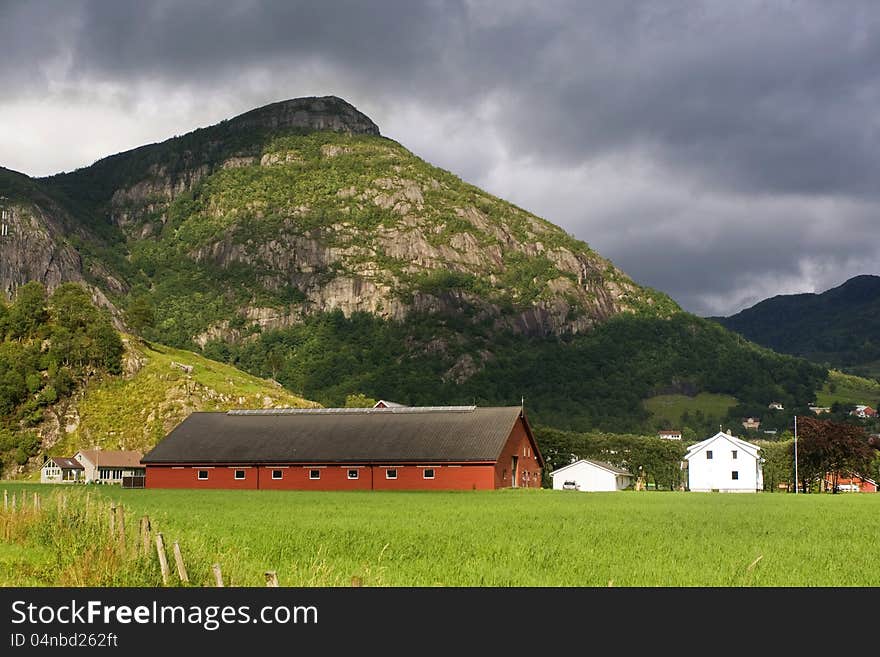 A village surrounded by green forested mountains in Norway. A village surrounded by green forested mountains in Norway.