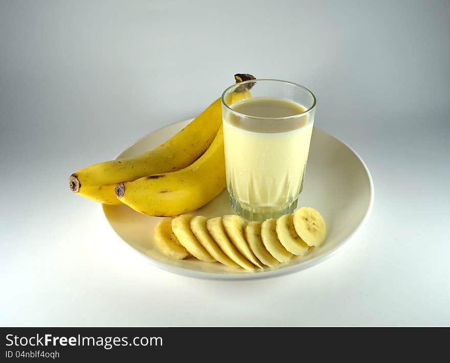 Big and long banana, pieces of banana and banana flavour milk