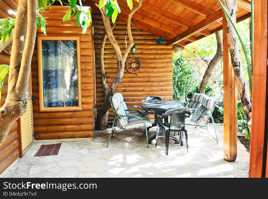 Veranda wooden houses with tiled floors and green trees around