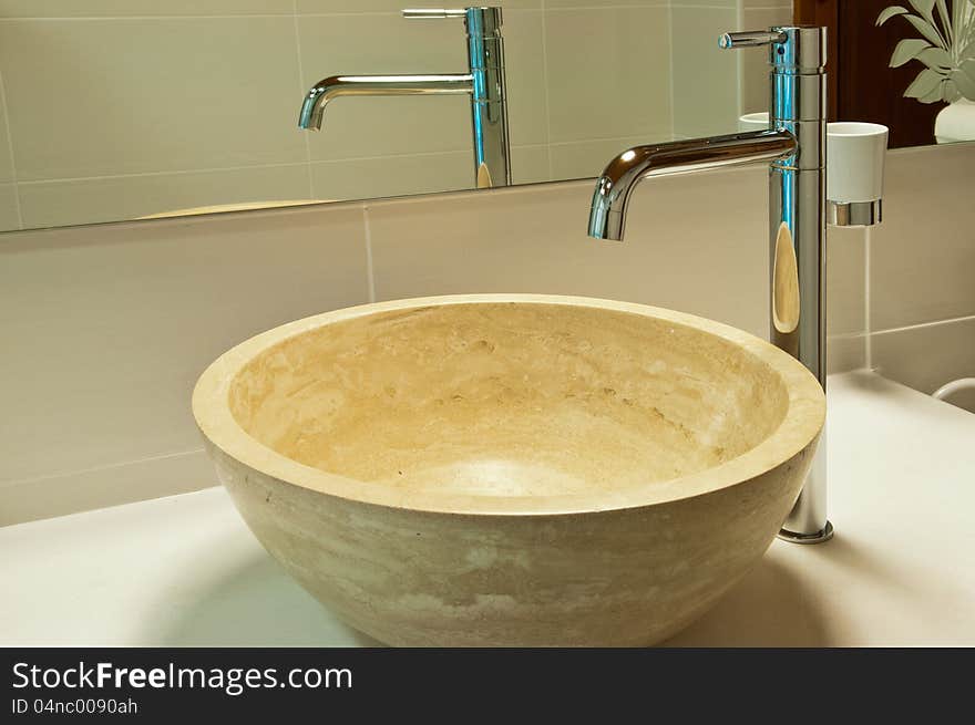 Sink and faucet in modern style in a wooden house, close-up. Sink and faucet in modern style in a wooden house, close-up