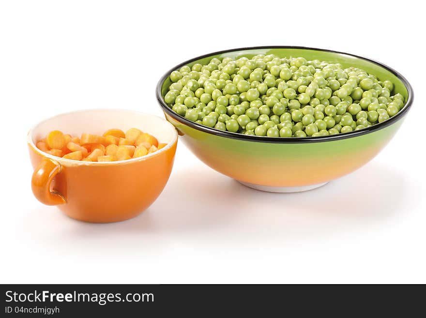 Carrots and peas in bowls