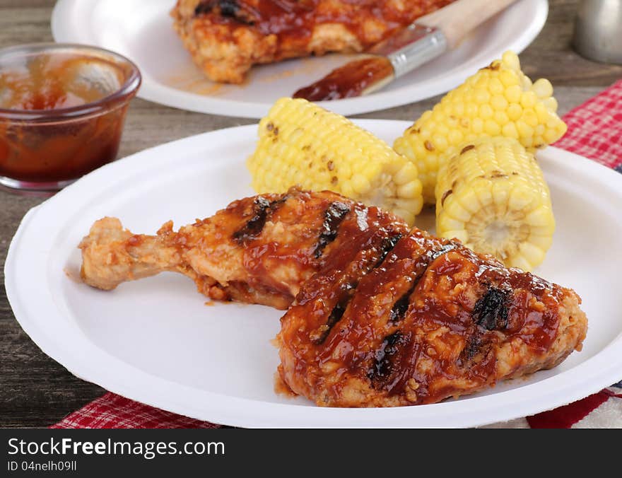 Grilled barbecue chicken and corn on a plate