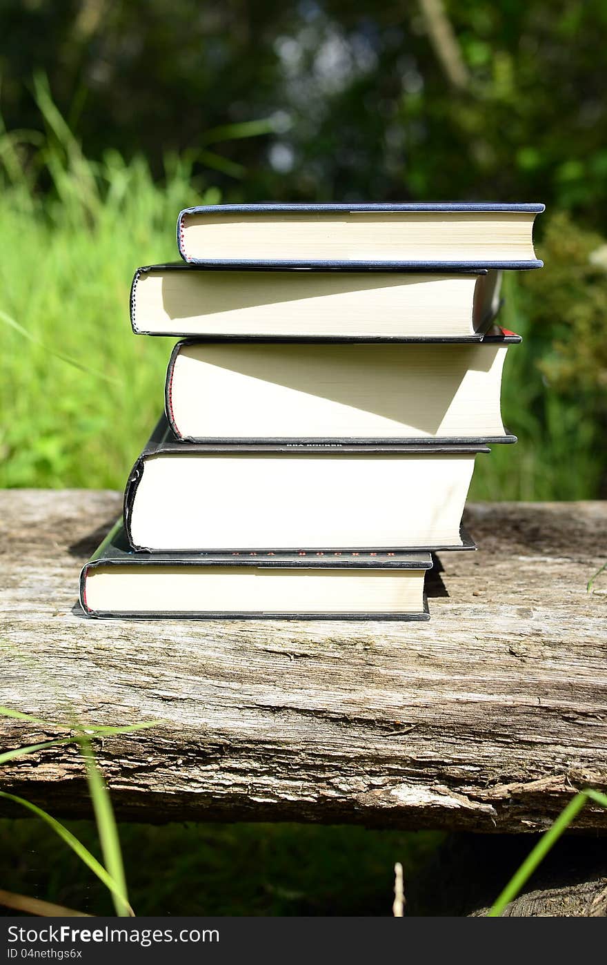 Books stacked on a bench vertical