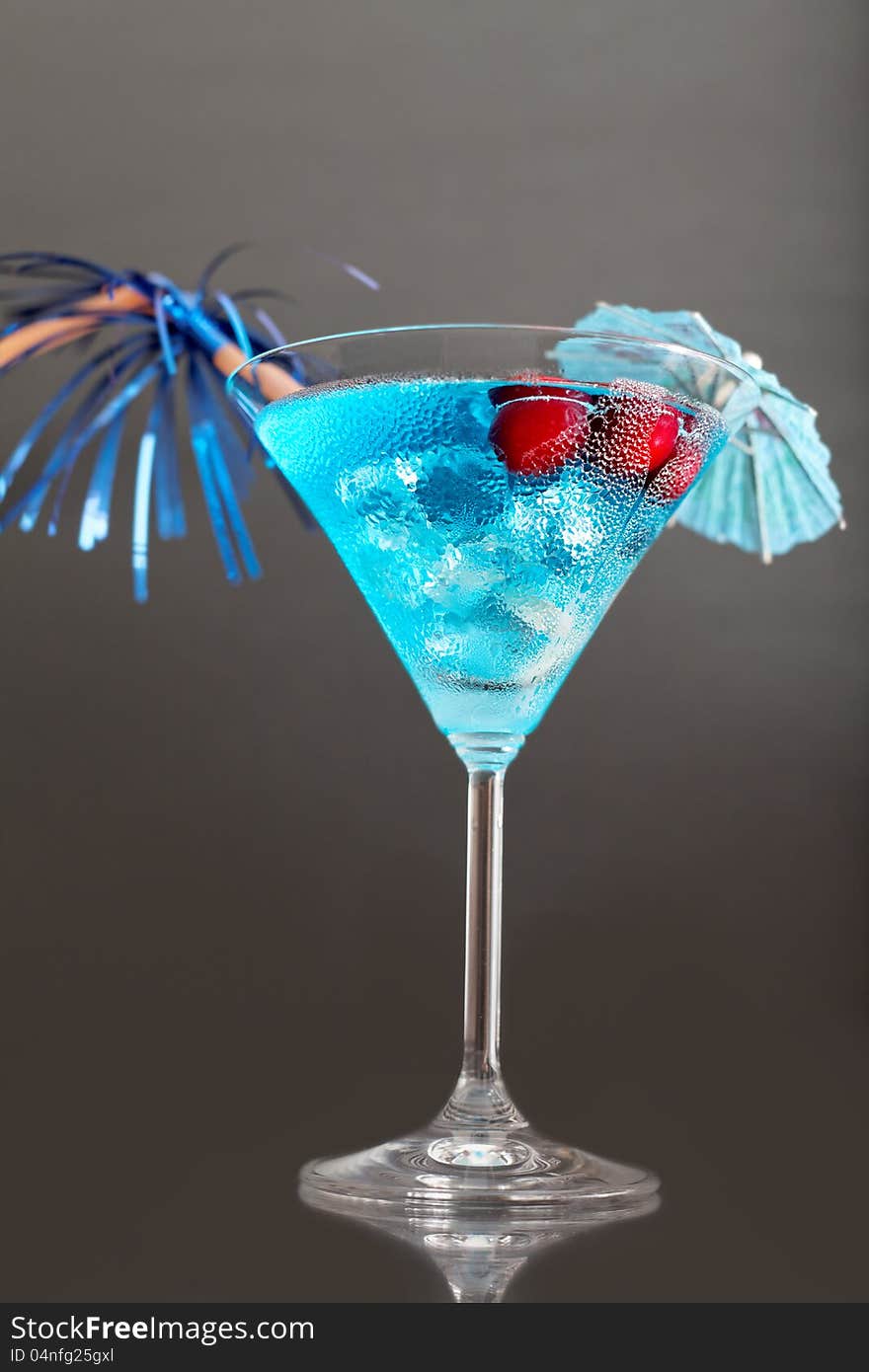 Blue cocktail with ice and umbrella