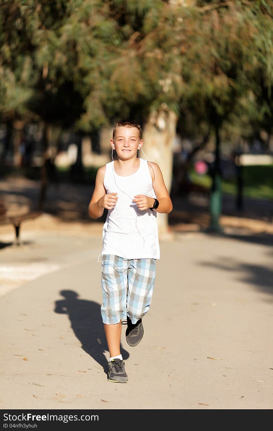 Boy running in summer park. Boy running in summer park