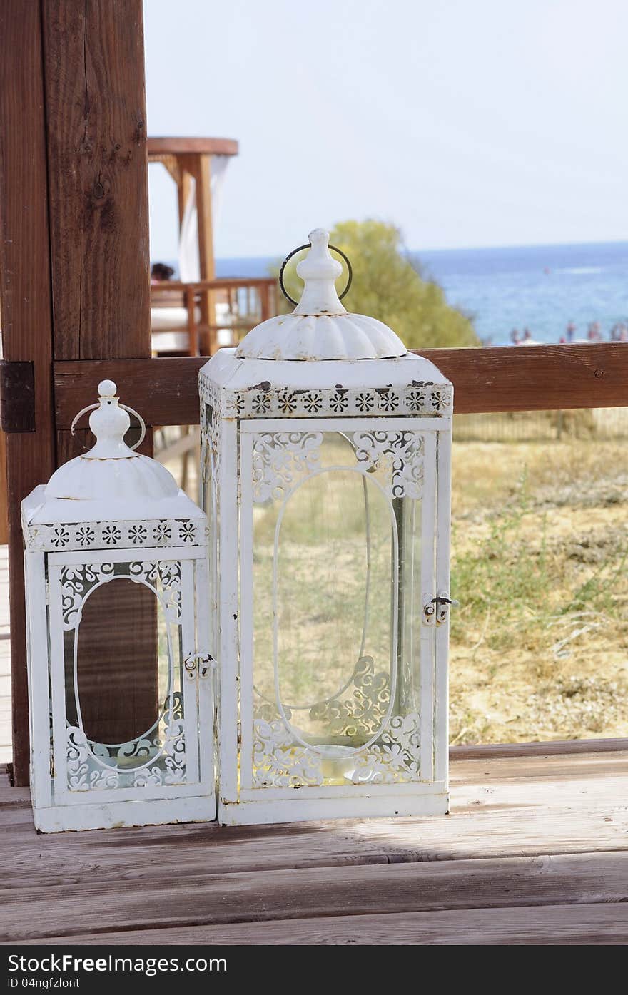 Candle lantern on a wooden deck at the beach, Algarve, Portugal..