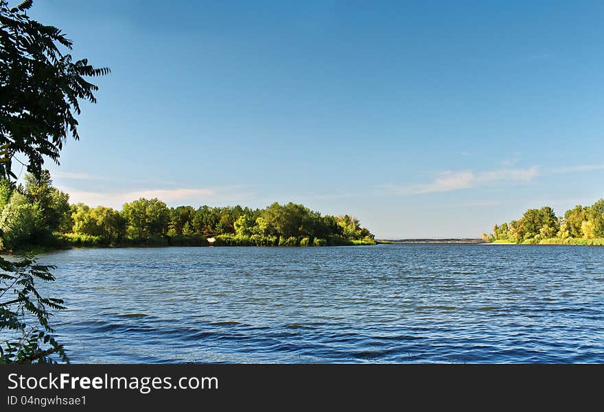 Lake pictures on the background of white clouds