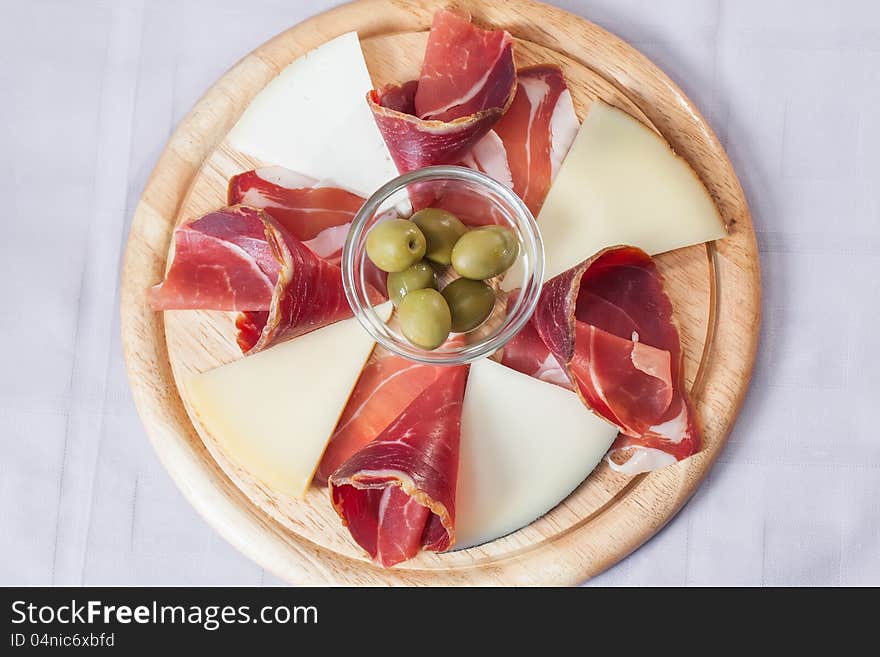 Cheese and bacon platter served with some olives. Cheese and bacon platter served with some olives.