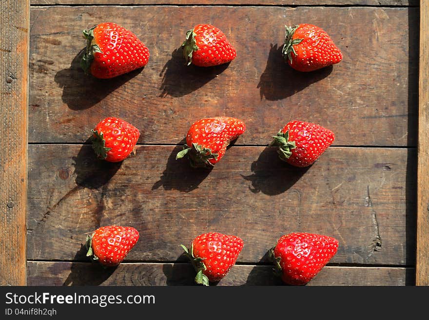 Few freshness red strawberries on wooden surface. Few freshness red strawberries on wooden surface