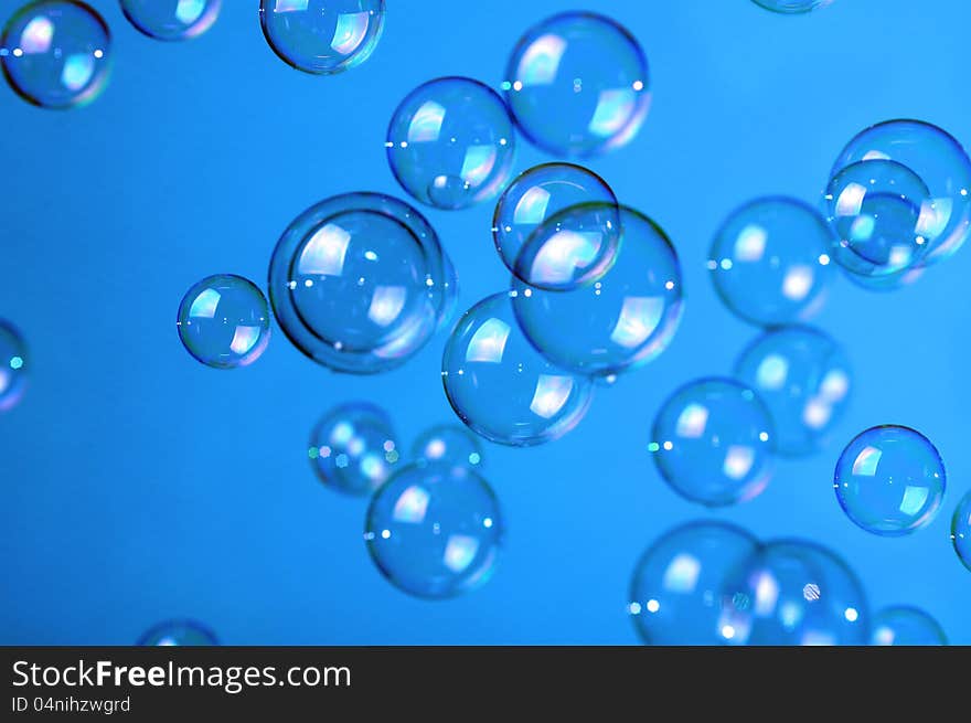 Soap bubbles on blue background